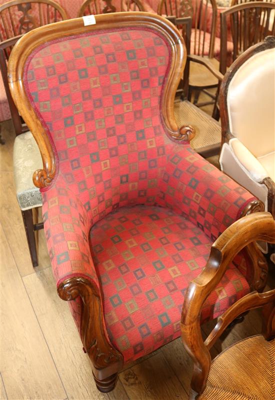 An upholstered spoonback armchair